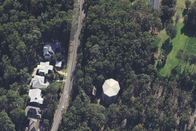 An aerial map view of bushland and houses