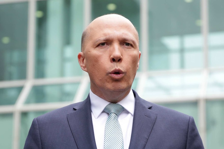 Peter Dutton talks to media outside Parliament