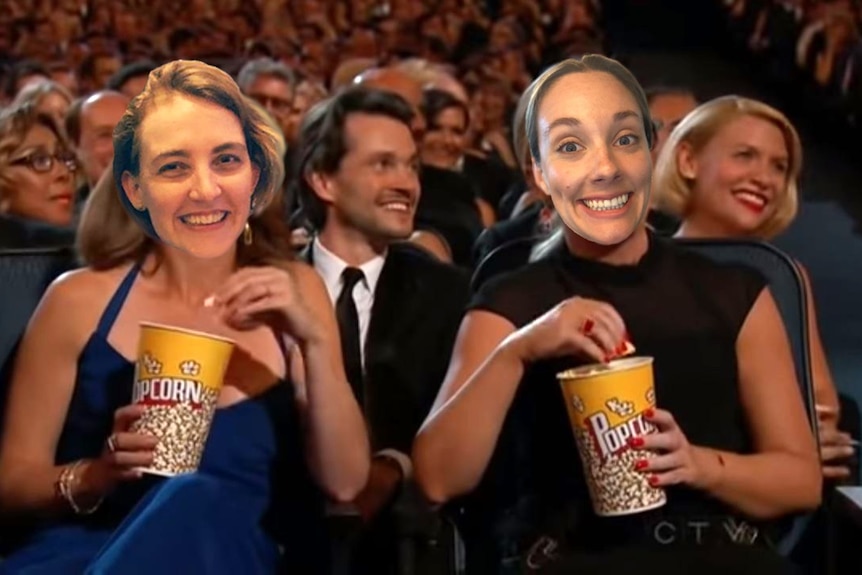 Two smiling women's faces superimposed over Tina Fey and Amy Poehler eating popcorn