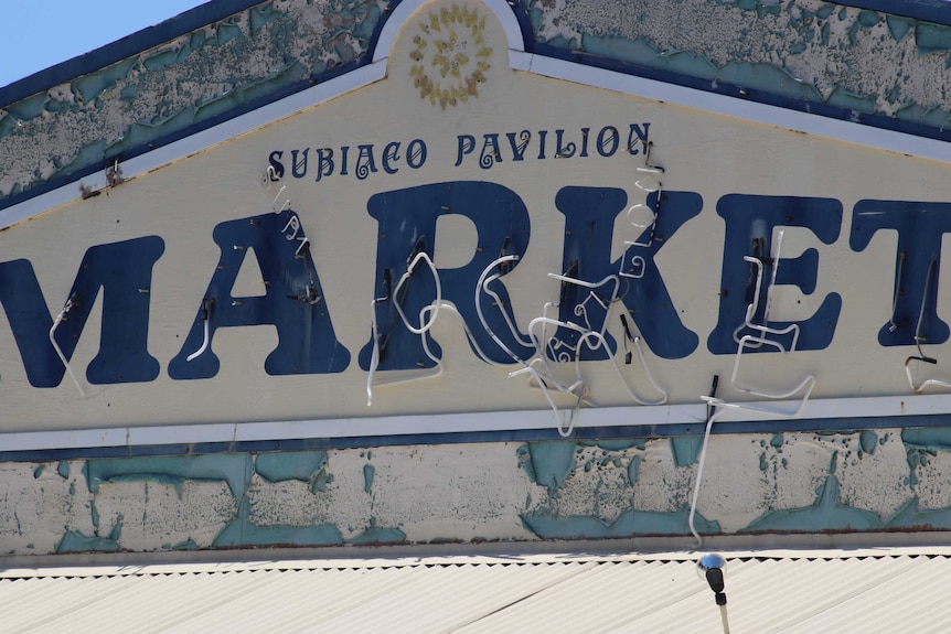 The old Subiaco Pavilion Market sign with neon lighting hanging off it.