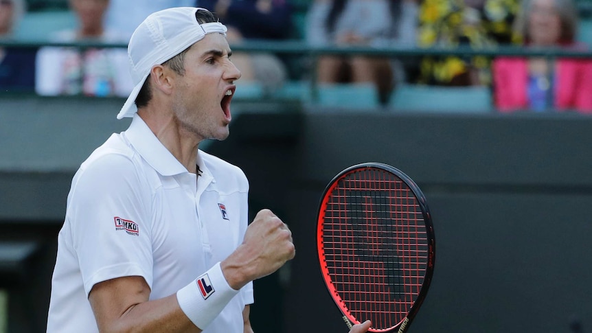 John Isner celebrates winning his quarterfinal against Milos Raonic at Wimbledon.