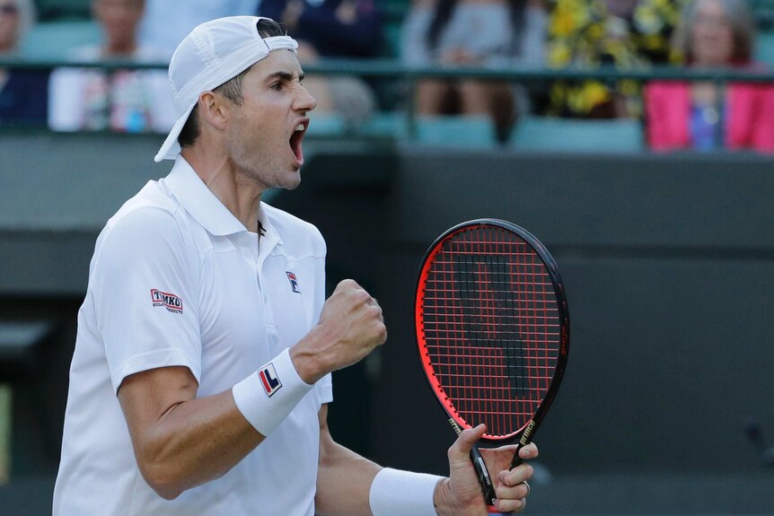 John Isner celebrates winning his quarterfinal against Milos Raonic at Wimbledon.