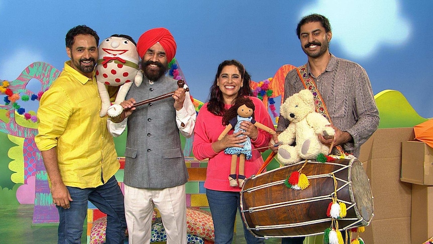 Presenters Leah and Nicholas with the Play School toys and musicians Devinder, holding a tumbi, and Harman, holding a dhol.