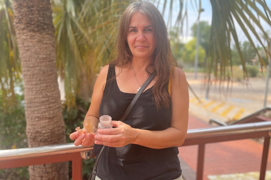 woman holds bottles 