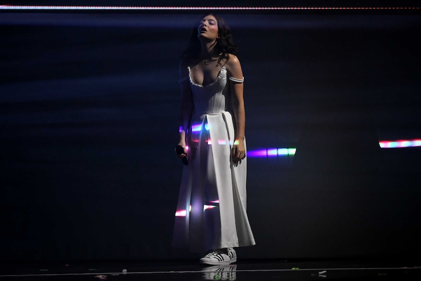 Lorde looking up in the middle of her performance.