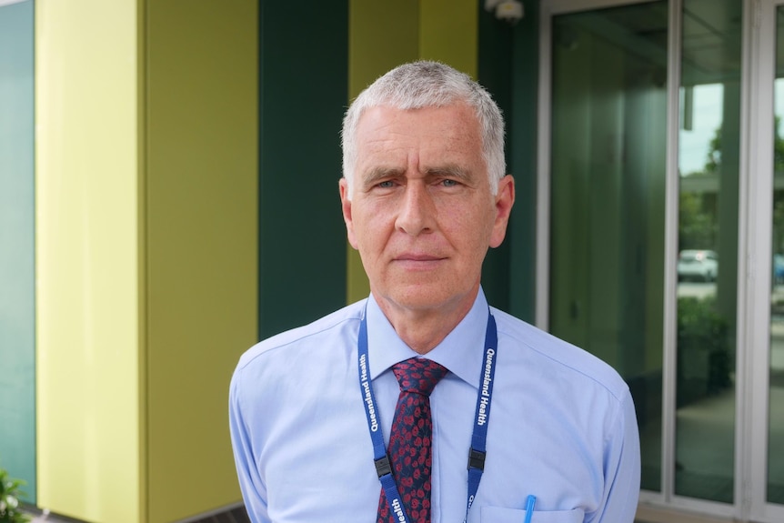 Man in suit looks at camera