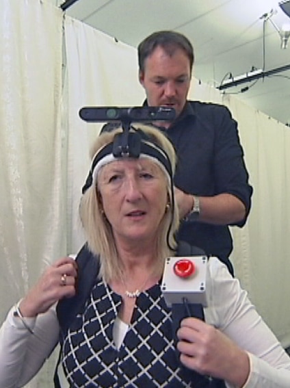 Dianne Ashworth wears a camera and other equipment to help her retinal implant see obstacles.