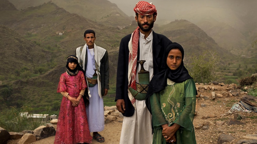 Tahani (in pink), who married her husband Majed when she was 6 and he was 25, poses for a portrait.
