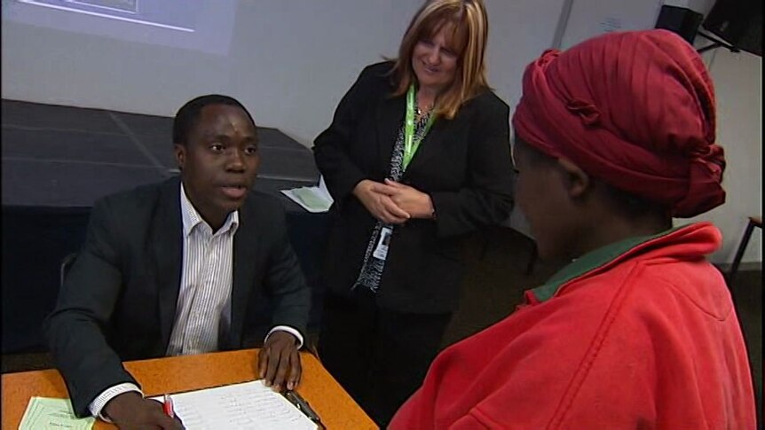 New Australian citizens practise casting their vote.