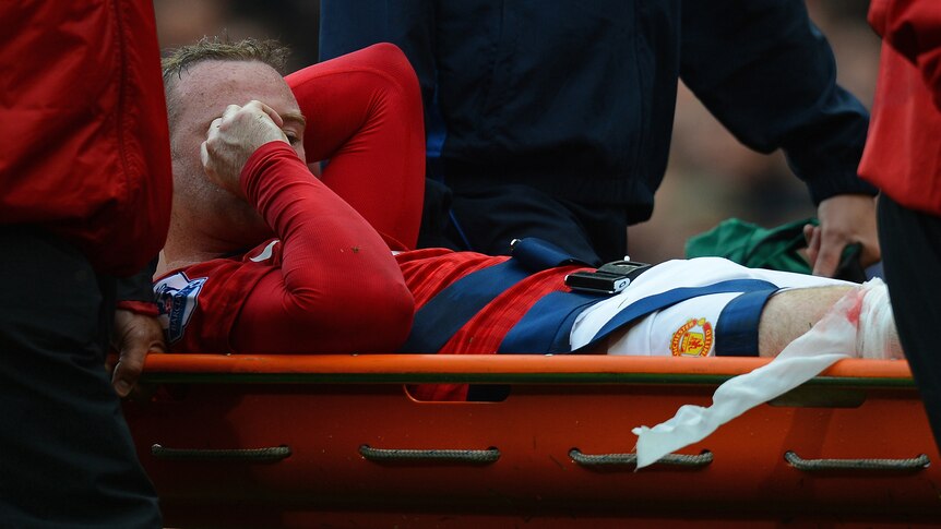 Rooney stretchered off