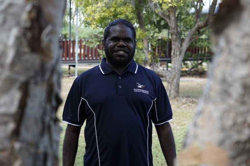 Mirarr traditional owner Simon Mudjandi stands smiling.