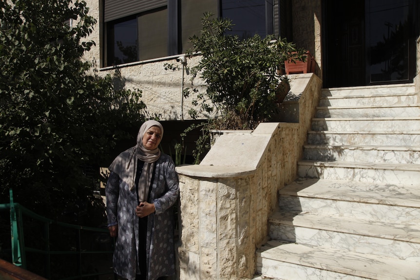 Asma' at the front of her Amman home.
