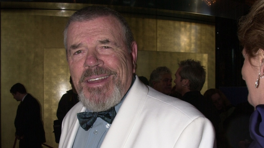 A photo of a man in a white tux 