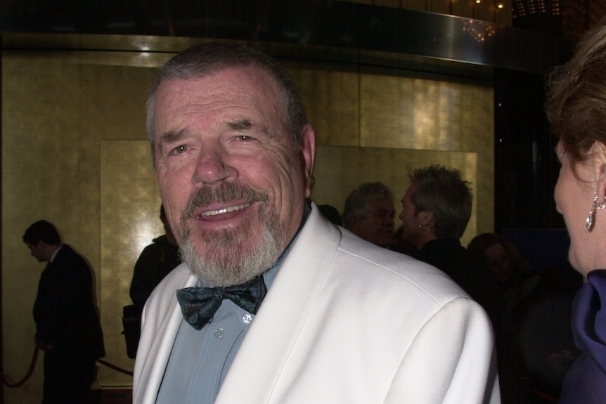 A photo of a man in a white tux 