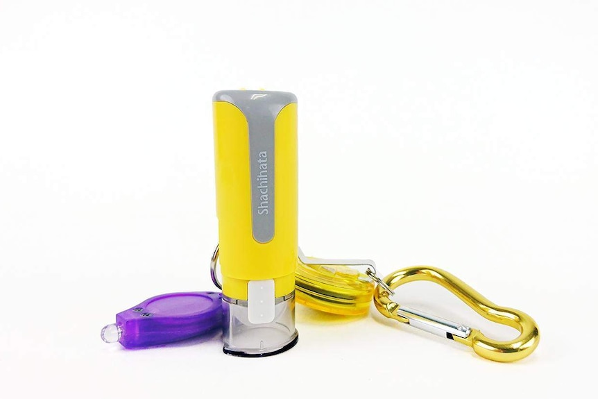 A yellow stamp with a carabina and a purple UV light.