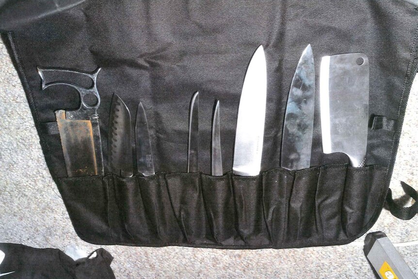 A set of knives held in a black apron found in the home of Jemma Lilley and Trudi Lenon.