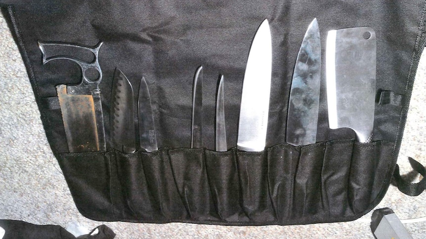 A set of knives held in a black apron found in the home of Jemma Lilley and Trudi Lenon.