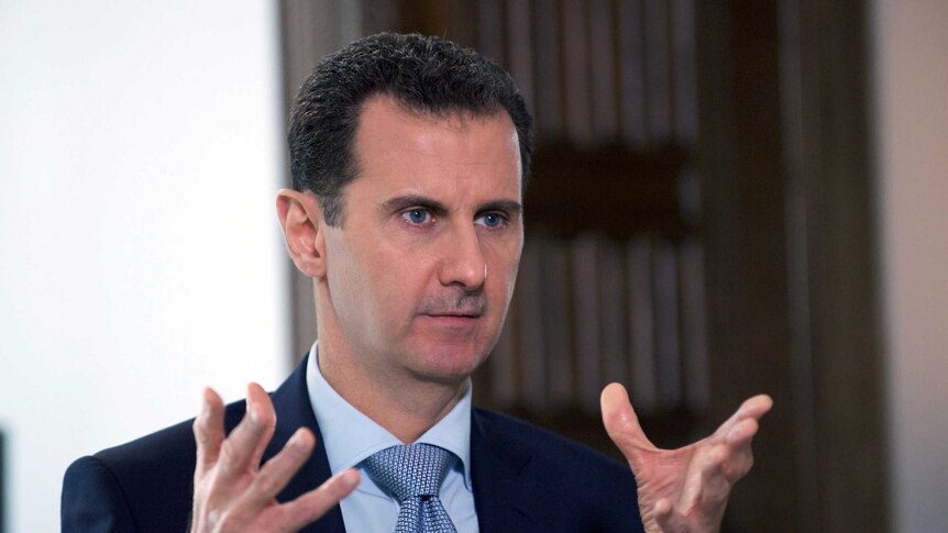 President Bashar al-Assad speaking to a journalist during an interview.