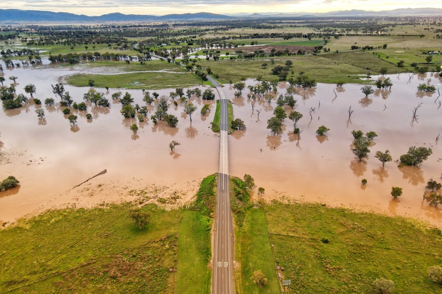 River floods across plains and out from under bridge