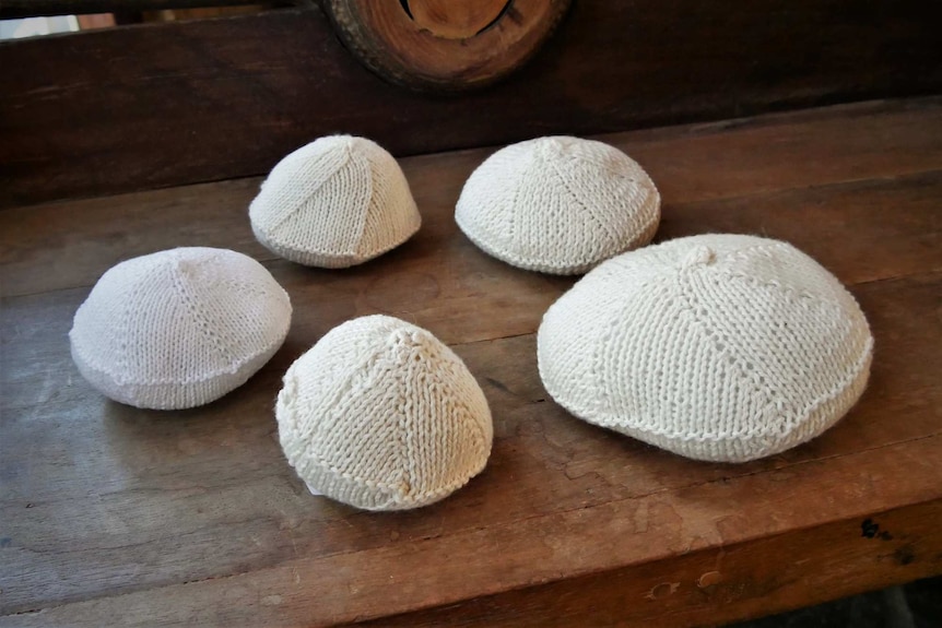 A collection of knitted knockers in a variety of different sizes.