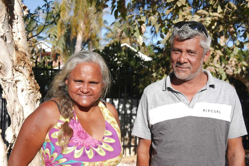 A woman and a man in a bush setting smile for the camera