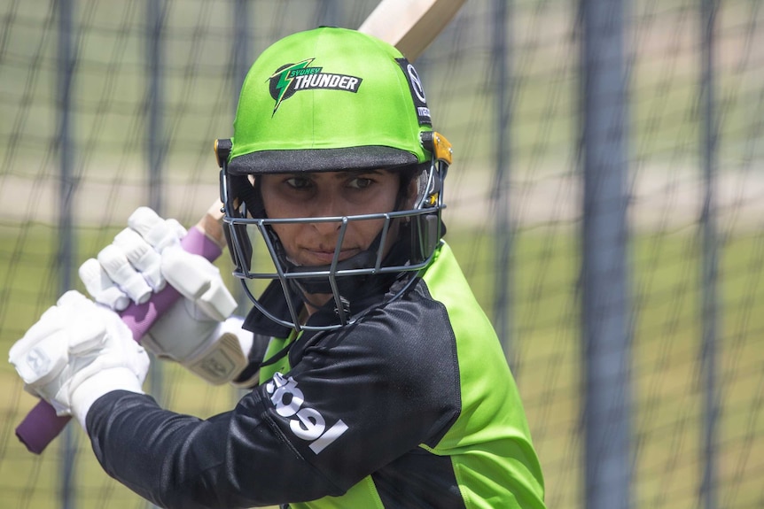 A Sydney Thunder WBBL player wearing a helmet during a net session.