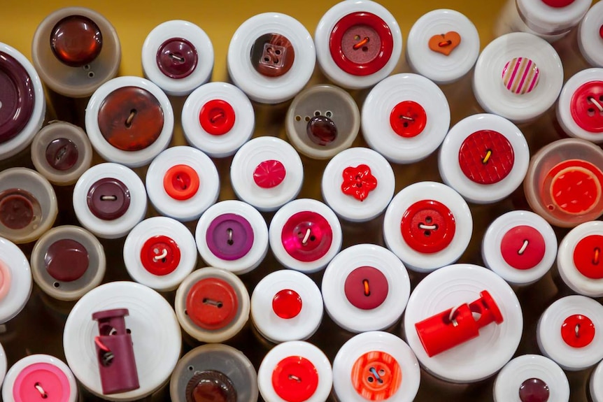 Red buttons in containers.