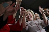 Clinton gives the thumbs up with supporters