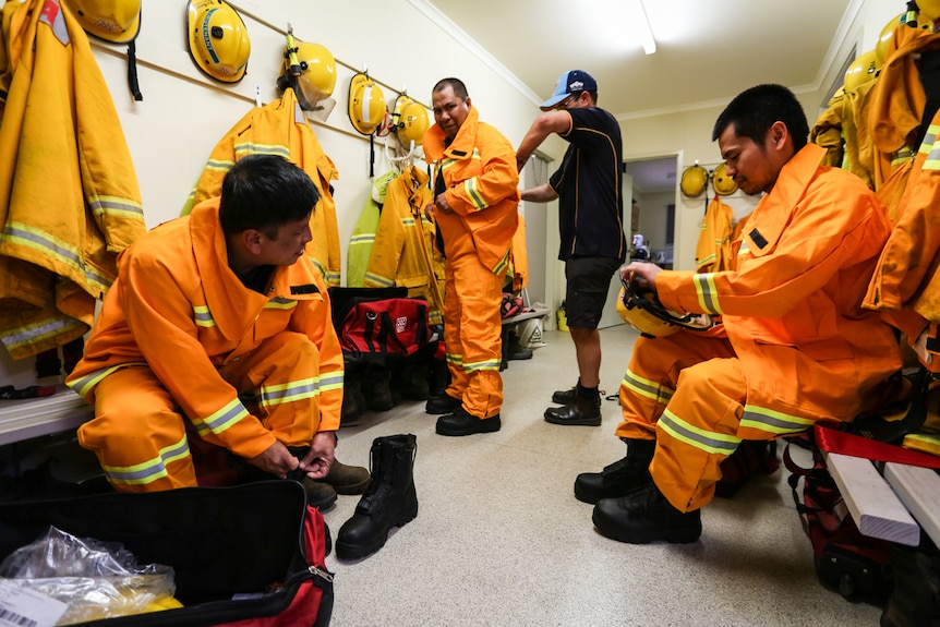 Three new Filipino CFA volunteers putting on their new uniforms.