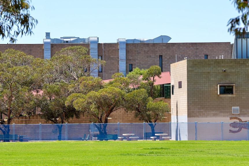 A blue fence surrounds large sections of a Broken Hill High School.