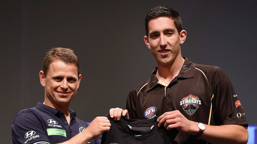 Carlton Football Club head coach Brendon Bolton (L) with the number one draft pick Jacob Weitering of the Carlton Football Club during the 2015 AFL Draft