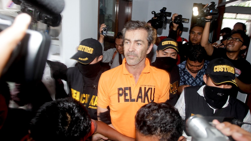 Australian Edward Myatt, 54, from Ballarat, being lead into Bali Customs Office in Kuta, Bali.