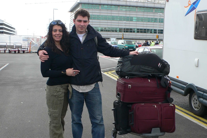 A couple at the airport with their bags packed.