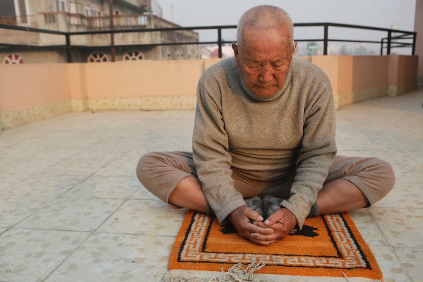 Nepalese mountain climber Min Bahadur Sherchan, does his morning yoga at his home in Kathmandu.