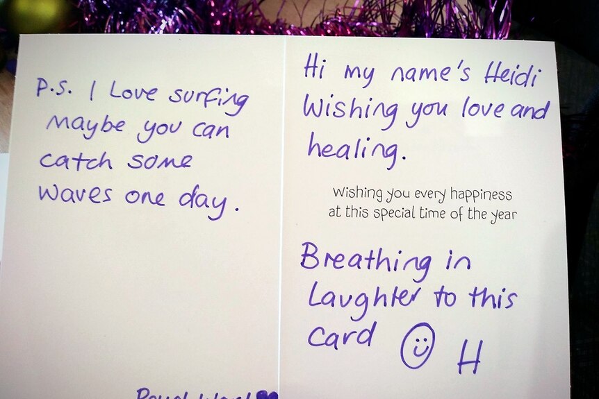 A Christmas card reads "wishing you love and healing".