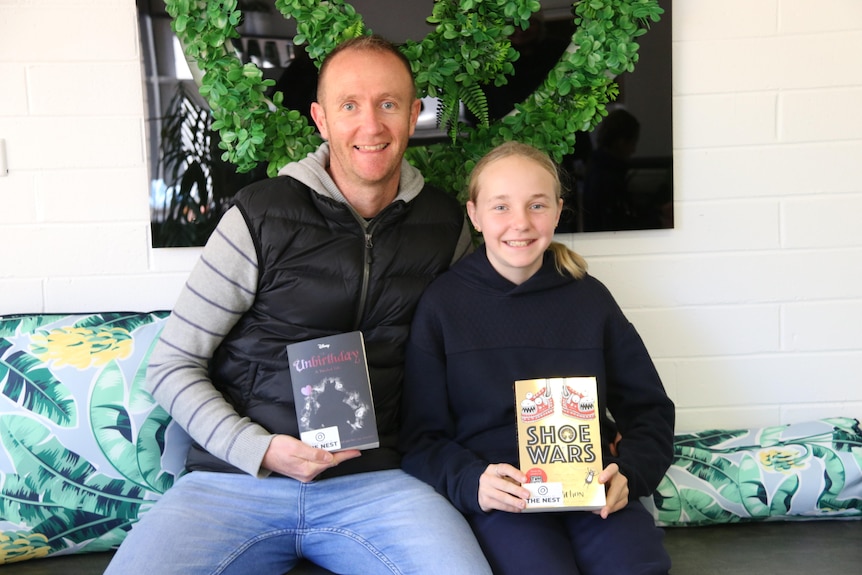 Man and girl reading books