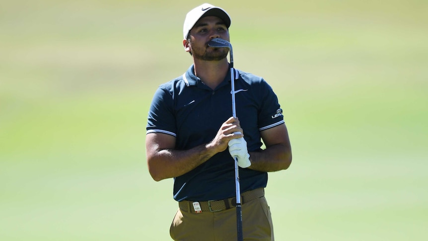 Jason Day holds his club after playing a shot at the 17th hole in round three of Australian Open.