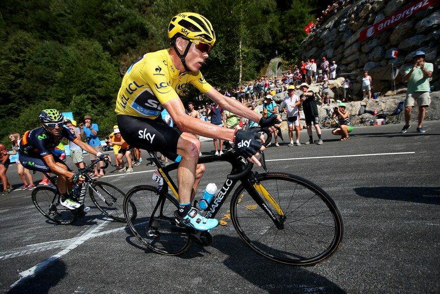 Chris Froome rides uphill in the yellow jersey