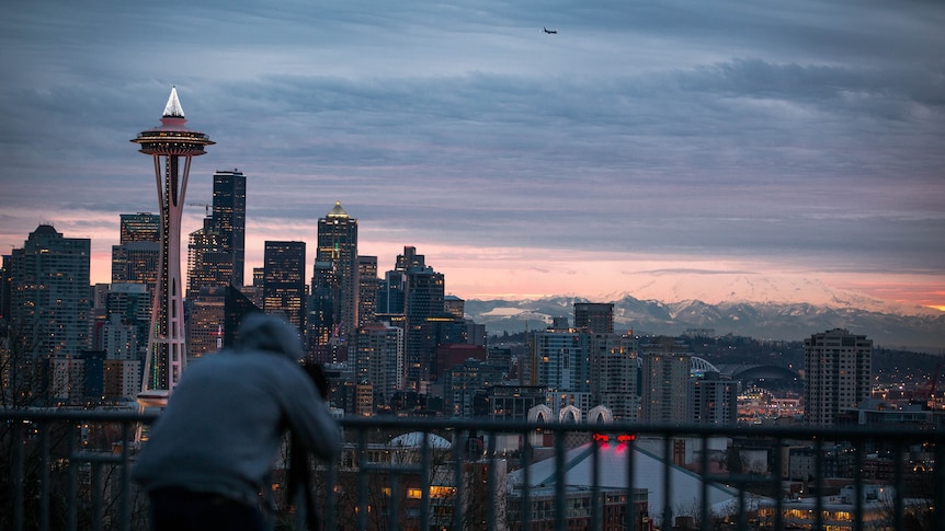 A twilight view of Seattle's city scape with its Space Needle in centre shot.