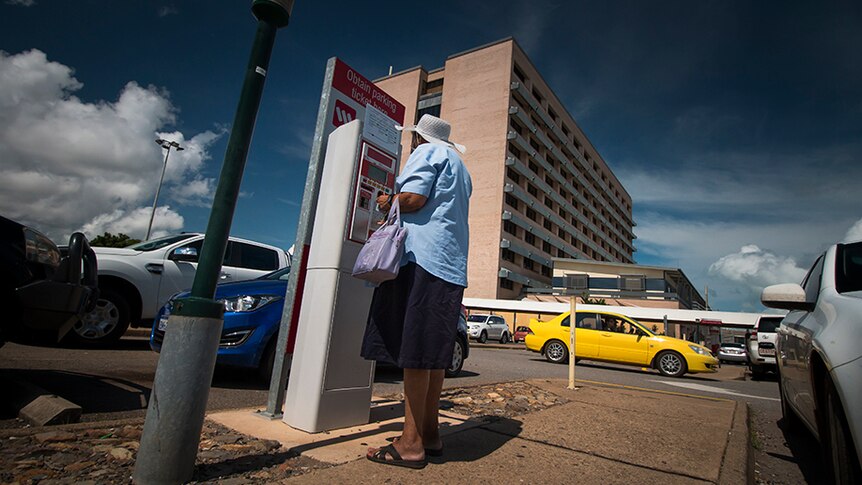 A driver collects her ticket at the Royal Darwin Hospital's car park.