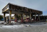 Photo shows burned out gas station after protests.