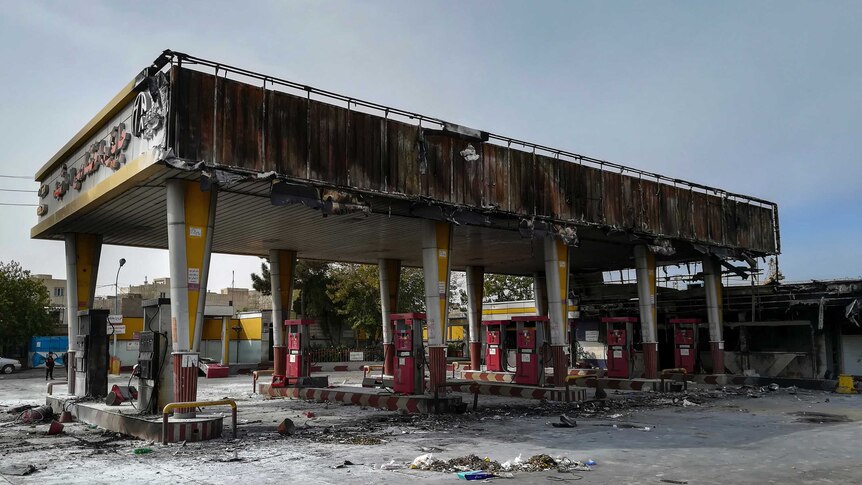 Photo shows burned out gas station after protests.