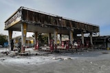 Photo shows burned out gas station after protests.