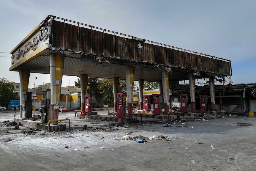 Photo shows burned out gas station after protests.