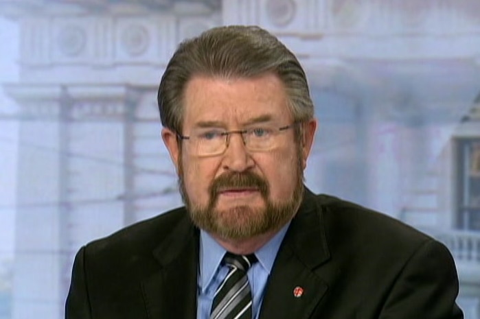 Derryn Hinch sits at a panel bench.