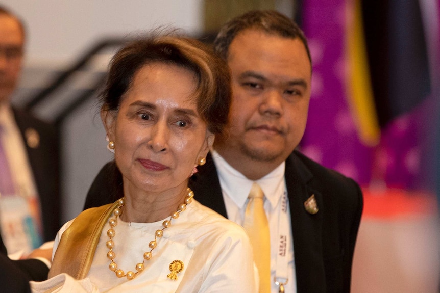 Myanmar leader Aung San Suu Kyi walks in to participate in the ASEAN leaders summit plenary session.
