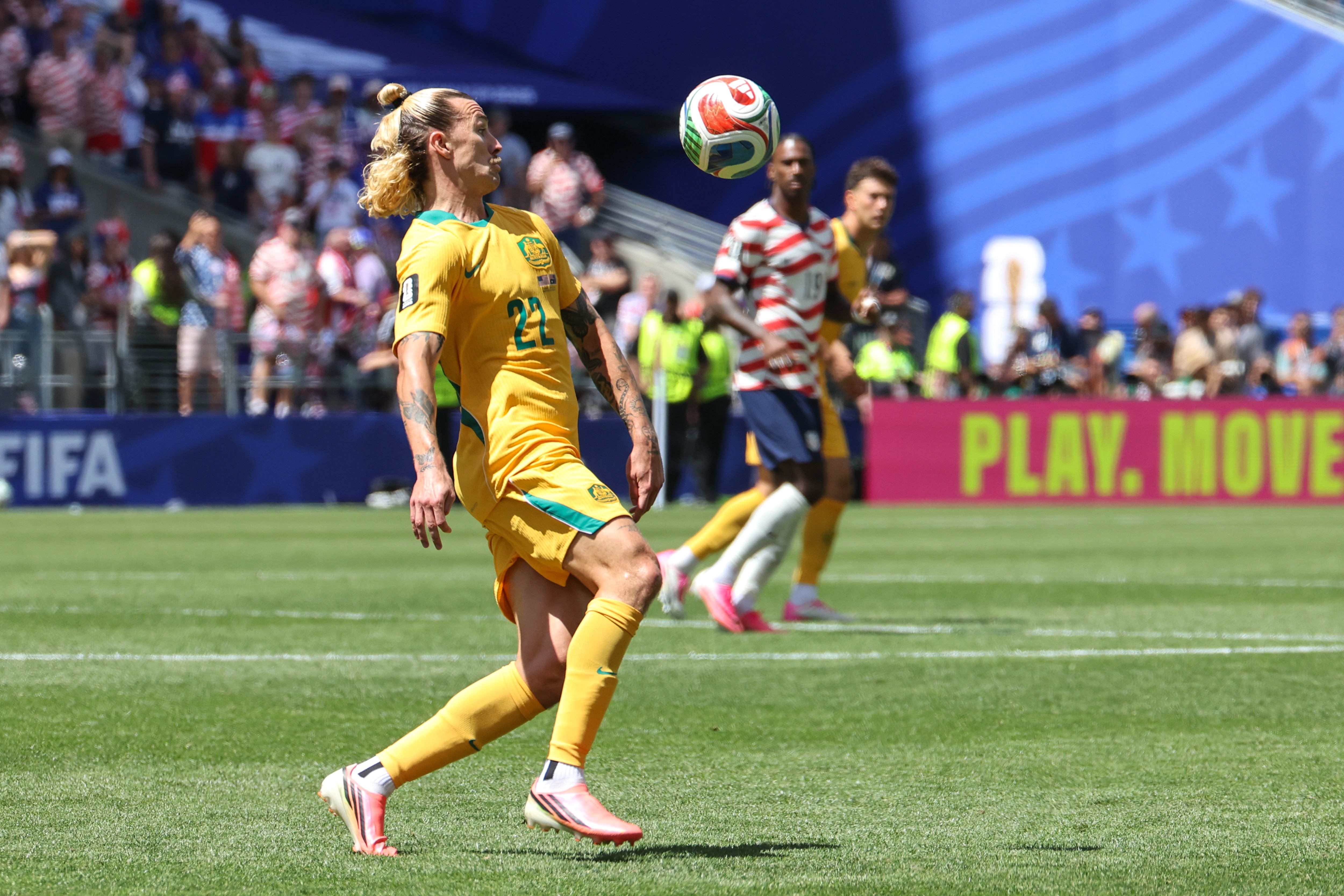 A soccer player controls the ball with his chest