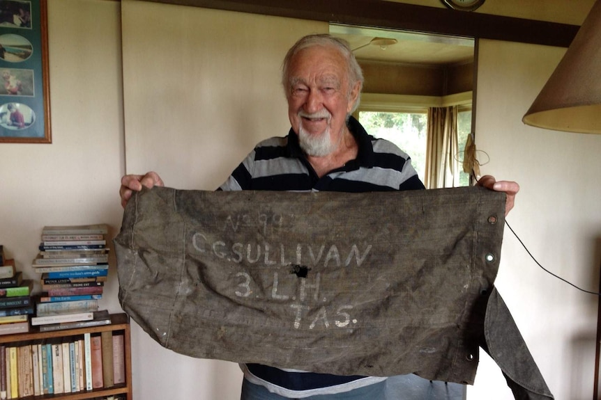 Len Sullivan holds his father's kit bag.