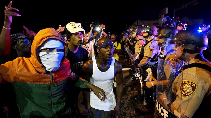 Protesters goad police on Ferguson anniversary