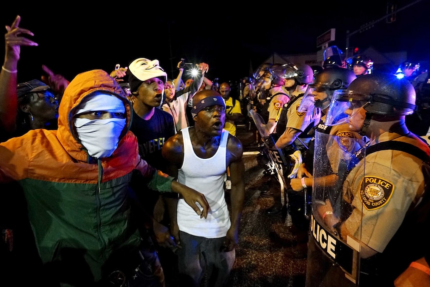 Protesters and police on Ferguson anniversary